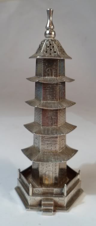 silver pepperette modelled as a pagoda. It bears the marks for Luen Wo 