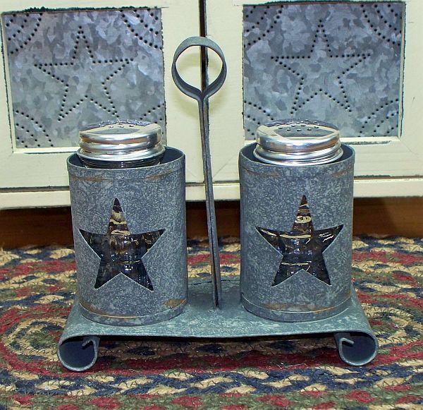   metal salt and pepper caddy with cutout stars and two clear glass